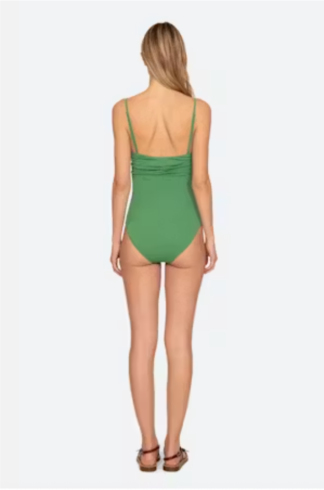 Woman wearing a green swimsuit on a white background