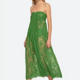 Woman wearing a green lace dress on a white background