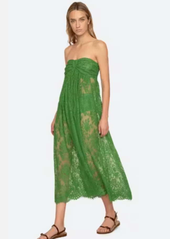 Woman wearing a green lace dress on a white background