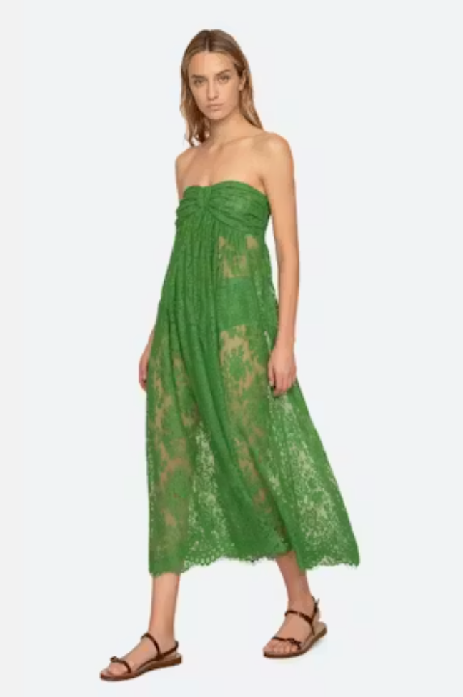 Woman wearing a green lace dress on a white background