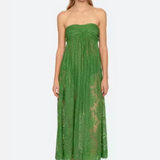 Woman wearing a green strapless lace dress on a white background