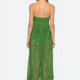 Woman wearing a green lace dress on a white background