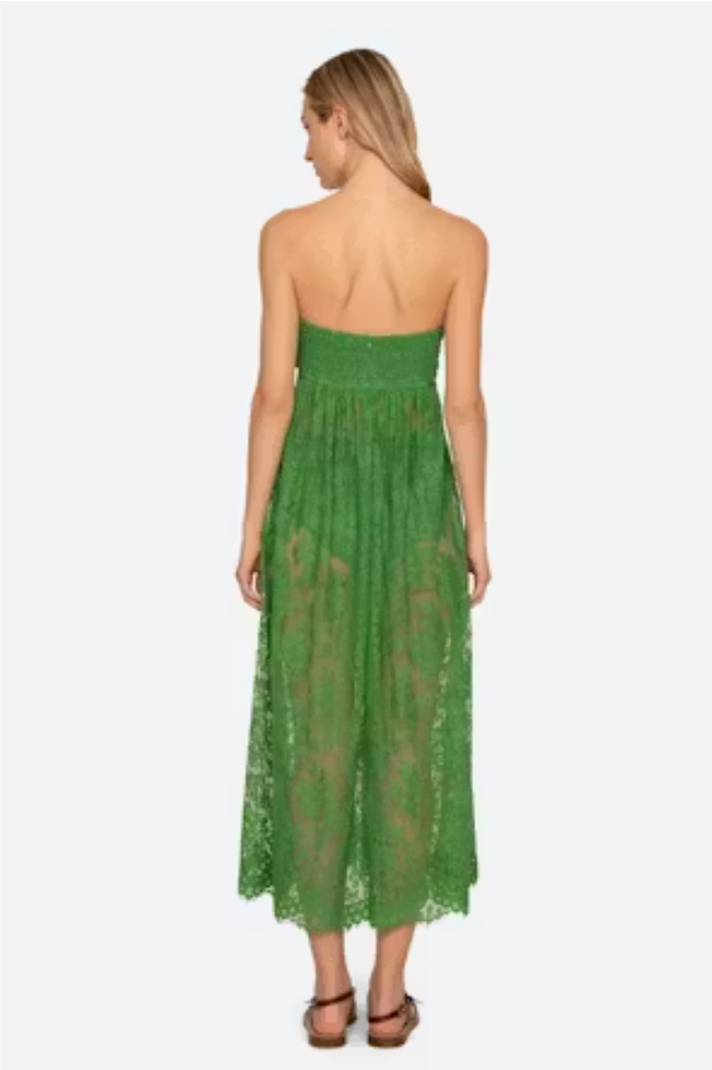 Woman wearing a green lace dress on a white background