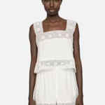 White lace dress worn by a model on a white background