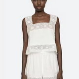 White lace dress worn by a model on a white background