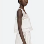 Woman wearing a white lace dress on a white background