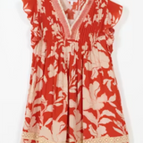Red floral dress with white flowers on a white background