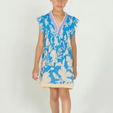 Young girl wearing a blue floral dress on a white background