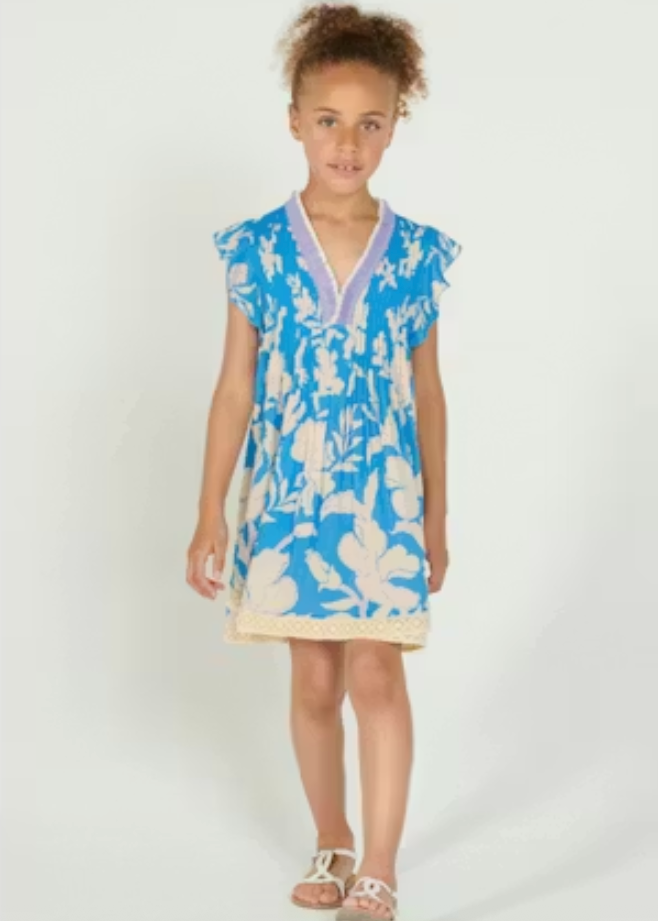Young girl wearing a blue floral dress on a white background