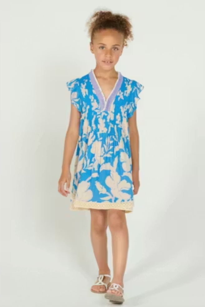 Young girl wearing a blue floral dress on a white background