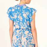 Woman wearing a blue floral outfit on a white background