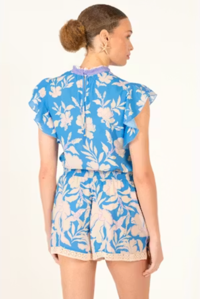 Woman wearing a blue floral outfit on a white background