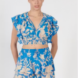 Woman wearing a blue floral two-piece outfit on a white background