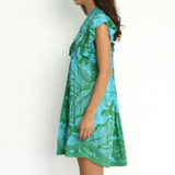 Woman wearing a green and blue patterned dress on a white background