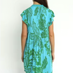 Woman wearing a blue and green patterned dress on a white background