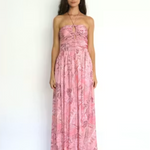 Woman wearing a pink floral dress on a white background