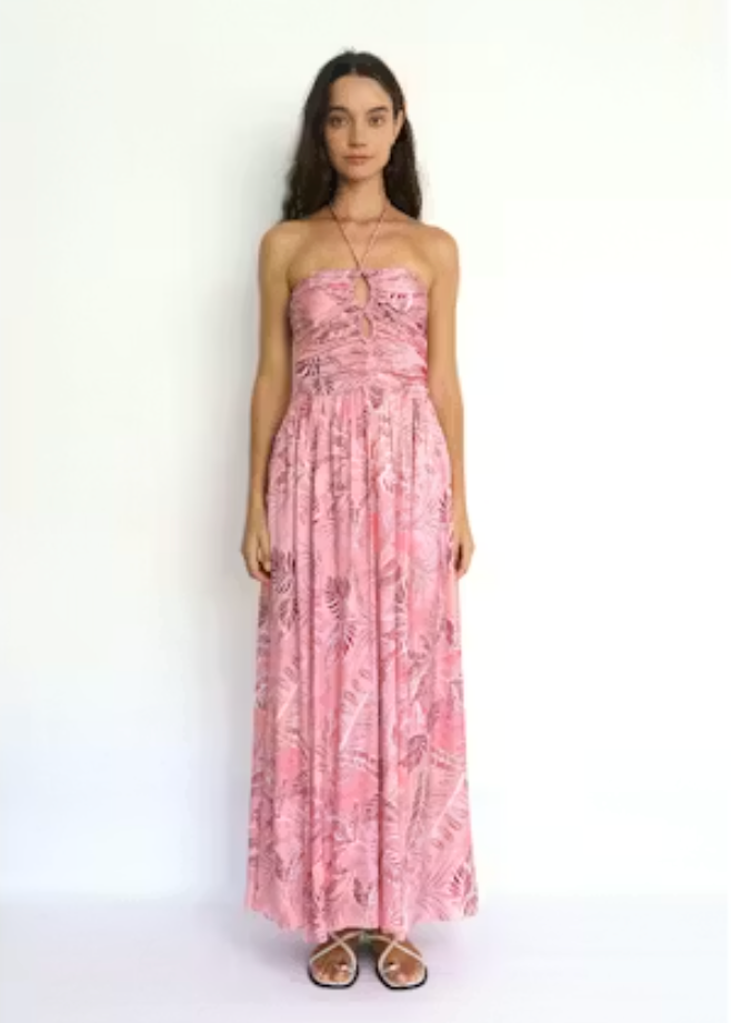 Woman wearing a pink floral dress on a white background