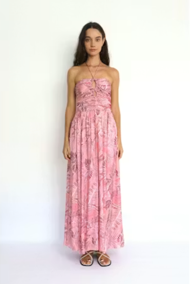 Woman wearing a pink floral dress on a white background
