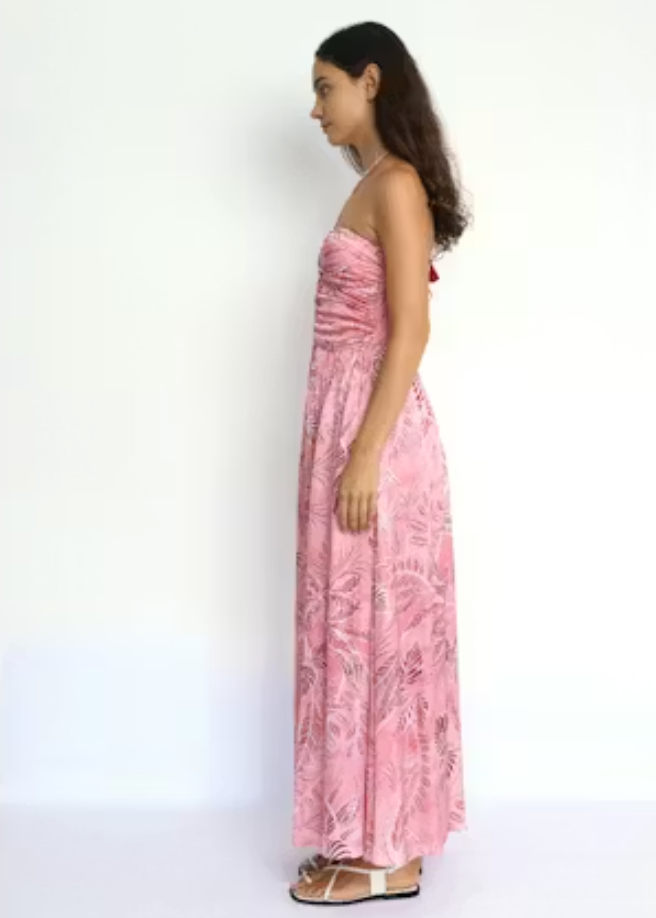 Woman wearing a pink floral dress against a white background