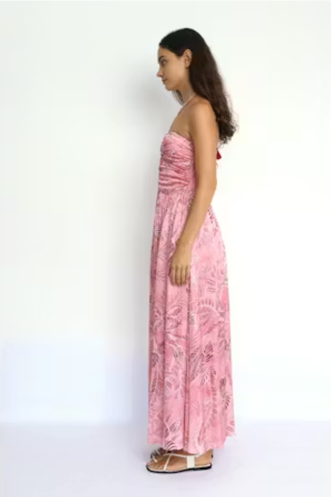 Woman wearing a pink floral dress against a white background
