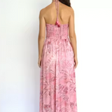 Woman wearing a pink floral dress on a white background