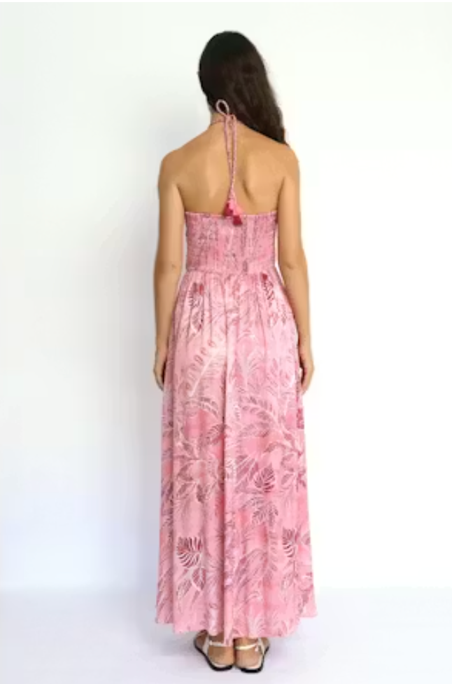 Woman wearing a pink floral dress on a white background