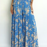 Person wearing a blue floral dress on a white background