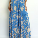 Person wearing a blue floral dress on a white background