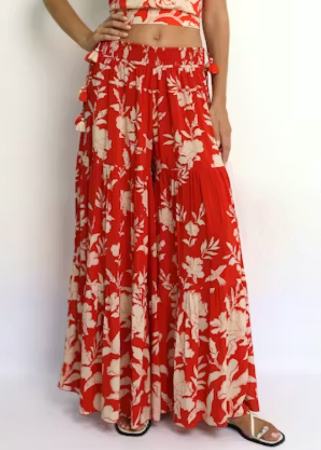Red and white floral outfit on a plain background
