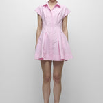 Woman wearing a pink dress against a white background