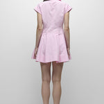Person wearing a pink dress on a white background