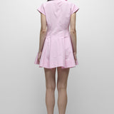 Person wearing a pink dress on a white background