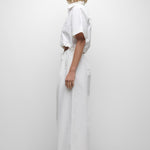 Person wearing a white outfit on a plain background