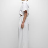 Person wearing a white outfit on a plain background