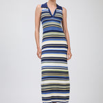 Woman wearing a long, multicolored striped dress on a white background
