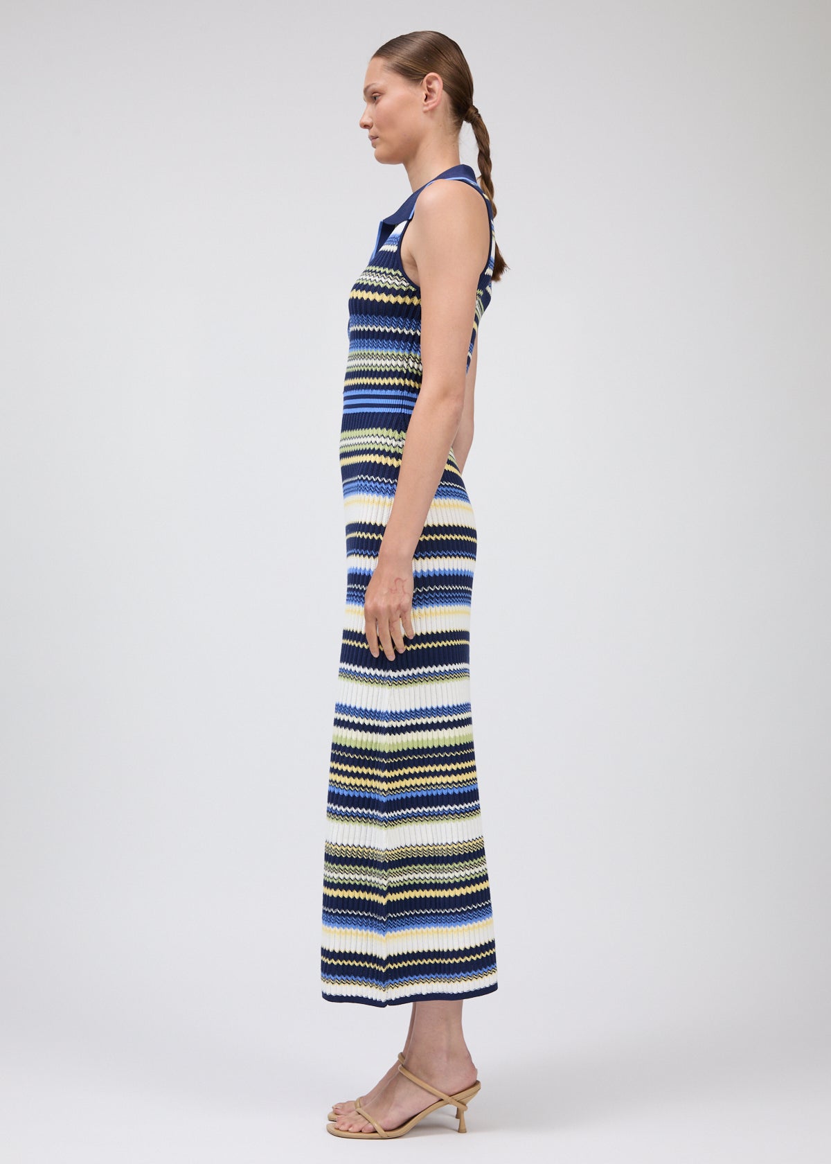 Woman wearing a striped dress on a white background