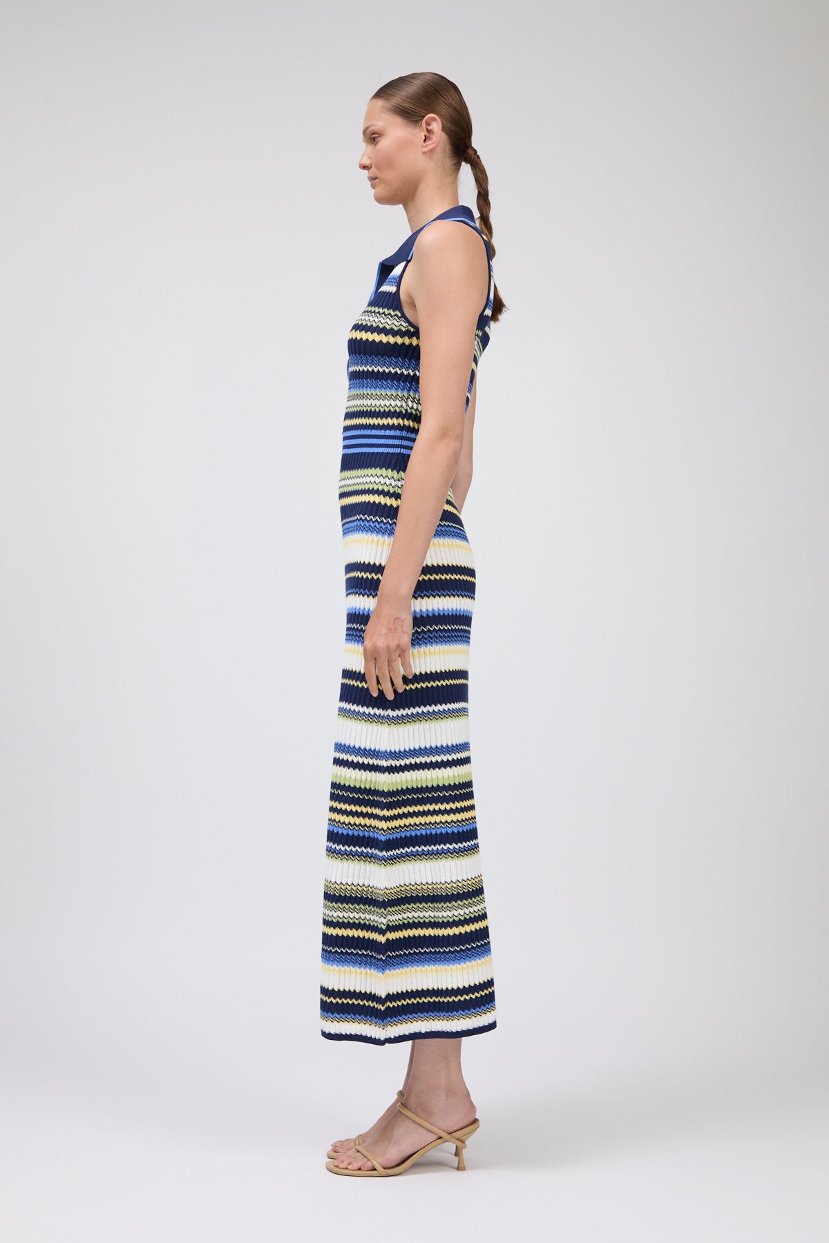 Woman wearing a striped dress on a white background