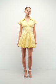 Woman wearing a yellow dress on a white background