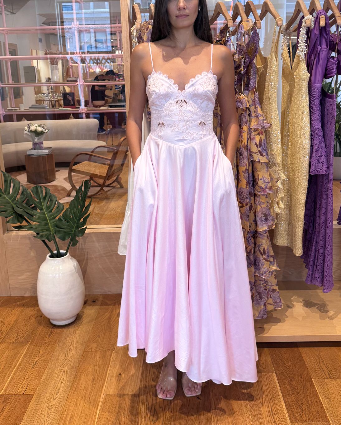 Woman wearing a white lace dress in a store setting