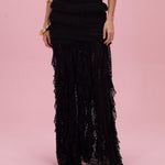 Black lace dress on a pink background
