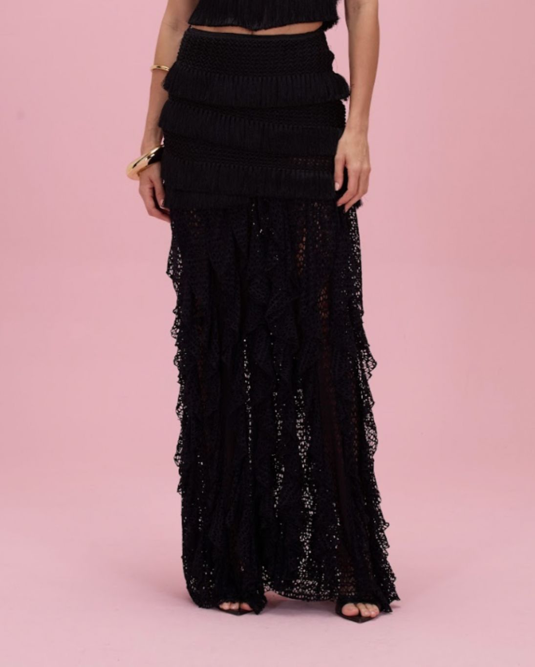 Black lace dress on a pink background