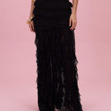 Black lace dress on a pink background