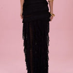Black layered skirt on a pink background
