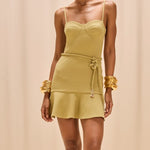 Woman wearing a light green dress with a beige background